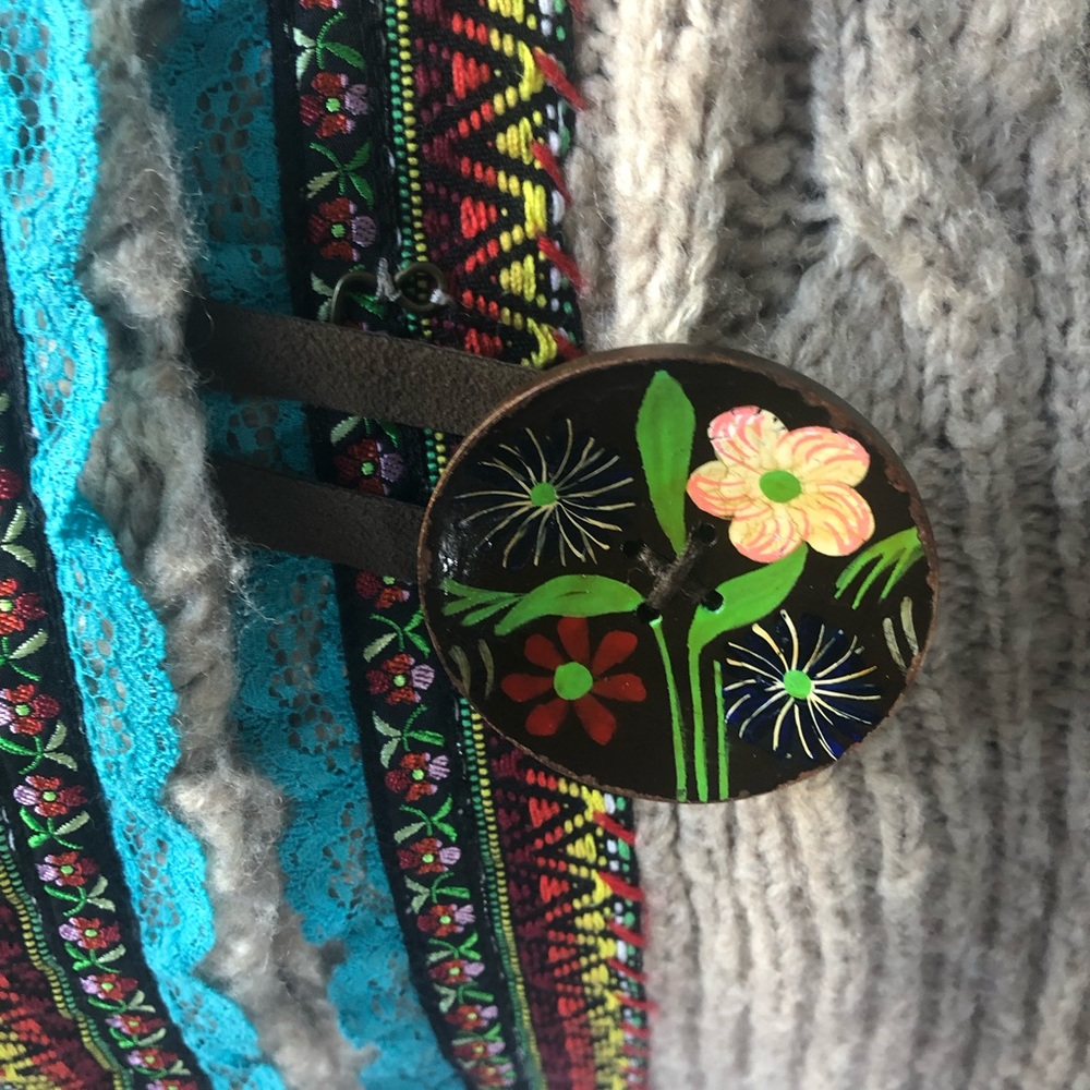 Free people. Sweater, hoodie with a colorful buckle.